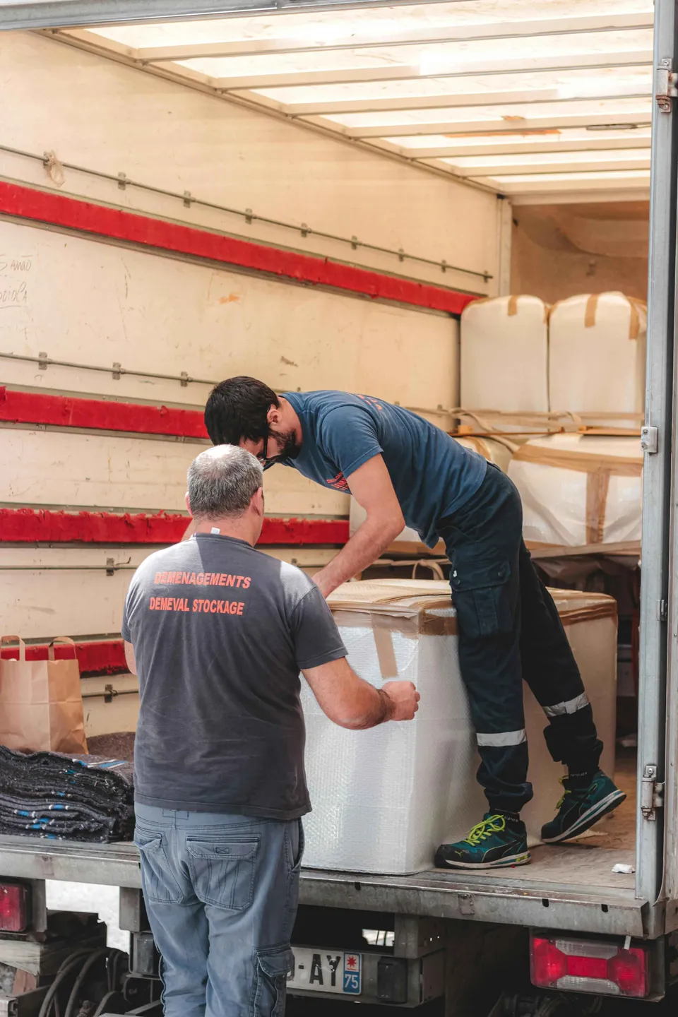 2 men unloading a truck after moving freight in Massachusetts